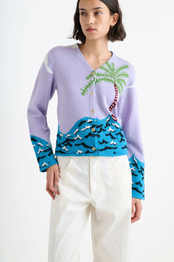 Front closeup picture of multi palm beach cardigan on model wearing white trousers, against a white background.