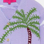 Front closeup view of multi palm beach cardigan laying on flat surface, against a white background.
