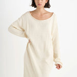 Front closeup view of natural nora lite oversized dress on dark-haired model, against a white background.