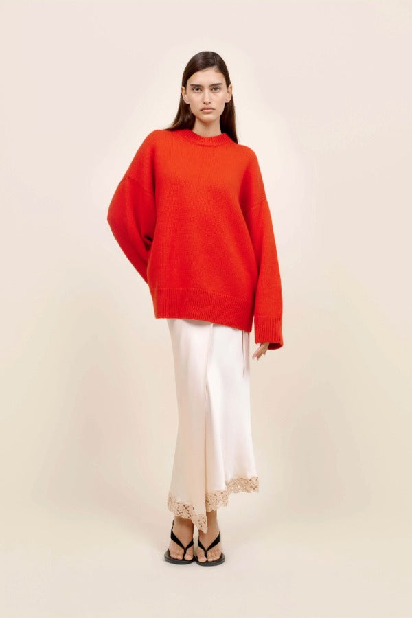 Front view of cherry pali crew on model wearing white slip and platforms, against a white background.