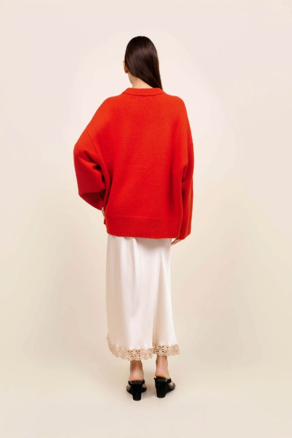 Back view of cherry pali crew on model wearing white slip and platforms, against a white background.