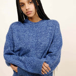 Front closeup view of storm zuma marl crew on model wearing blue skirt, against a white background.