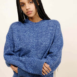 Front closeup view of storm zuma marl crew on model wearing blue skirt, against a white background.