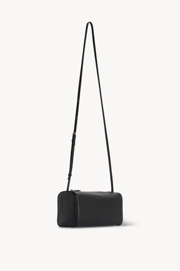 Front slanted view of black 90's crossbody bag on white background, with no model shown.