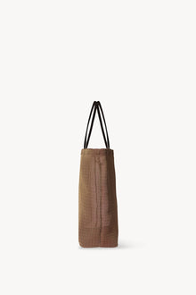 Side view of mesh and leather bag in acero on white background, with no model shown.