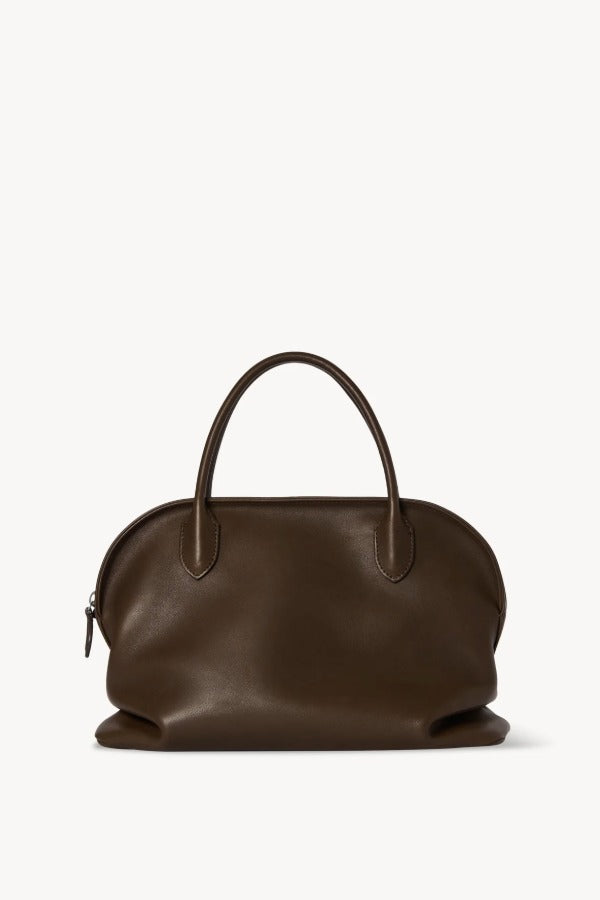 Front view of deep brown agnes bag on white background, with no model shown.