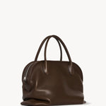 Front slanted view of deep brown agnes bag on white background with no model shown.