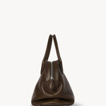 Side view of deep brown agnes bag on white background, with no model shown.