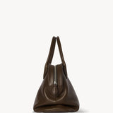 Side view of deep brown agnes bag on white background, with no model shown.