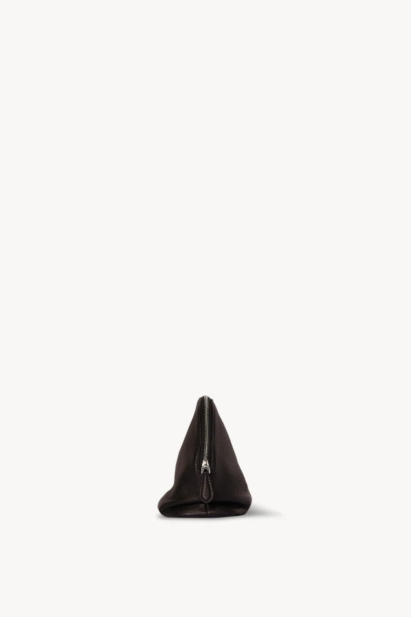 Side view of dark brown agnes pouch on white background, with no model shown.