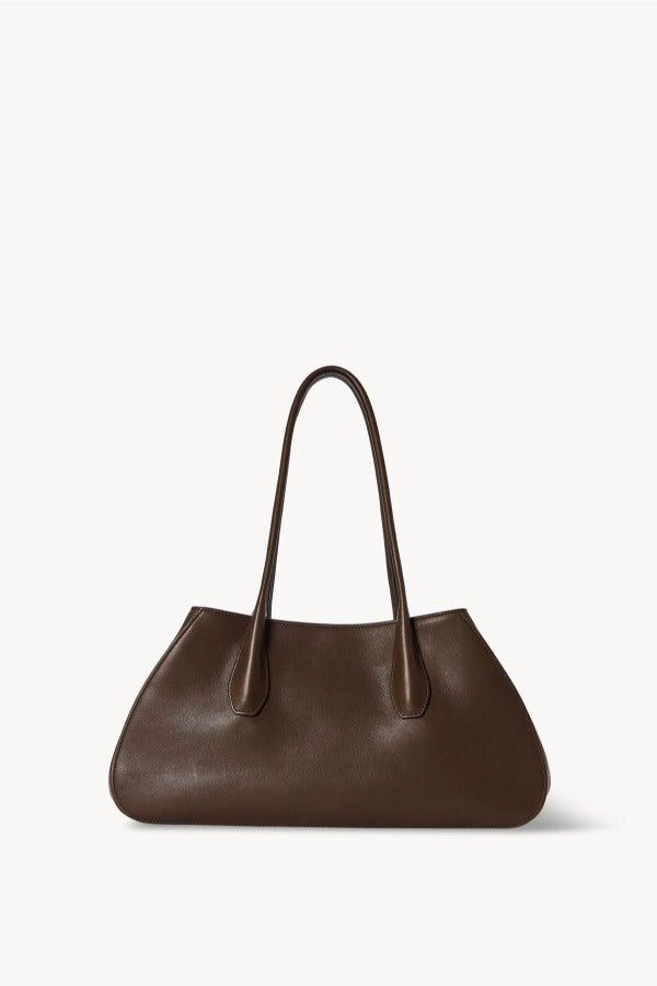 Front view of deep brown alger shoulder bag on white background, with no model shown.