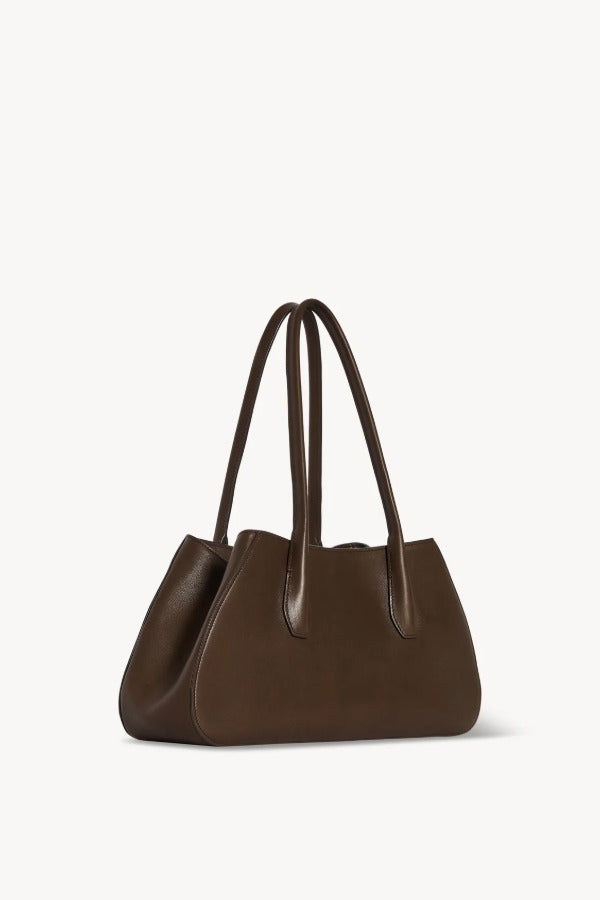 Front slanted view of deep brown alger shoulder bag on white background, with no model shown.