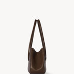 Side view of deep brown alger shoulder bag on white background, with no model shown.
