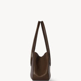 Side view of deep brown alger shoulder bag on white background, with no model shown.