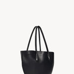 Side slanted view of black alger tote on white background, with no model shown.