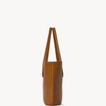Side view of cuir alger tote on white background, with no model shown.