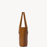 Side view of cuir alger tote on white background, with no model shown.