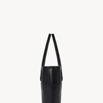 Side view of black alger tote on white background, with no model shown.