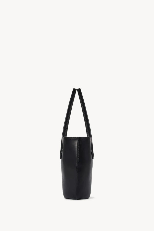 Side view of black alger tote on white background, with no model shown.