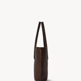 Side view of deep brown alger tote on white background, with no model shown.