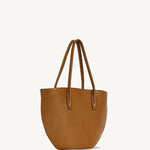 Front slanted view of cuir alger tote on white background, with no model shown.