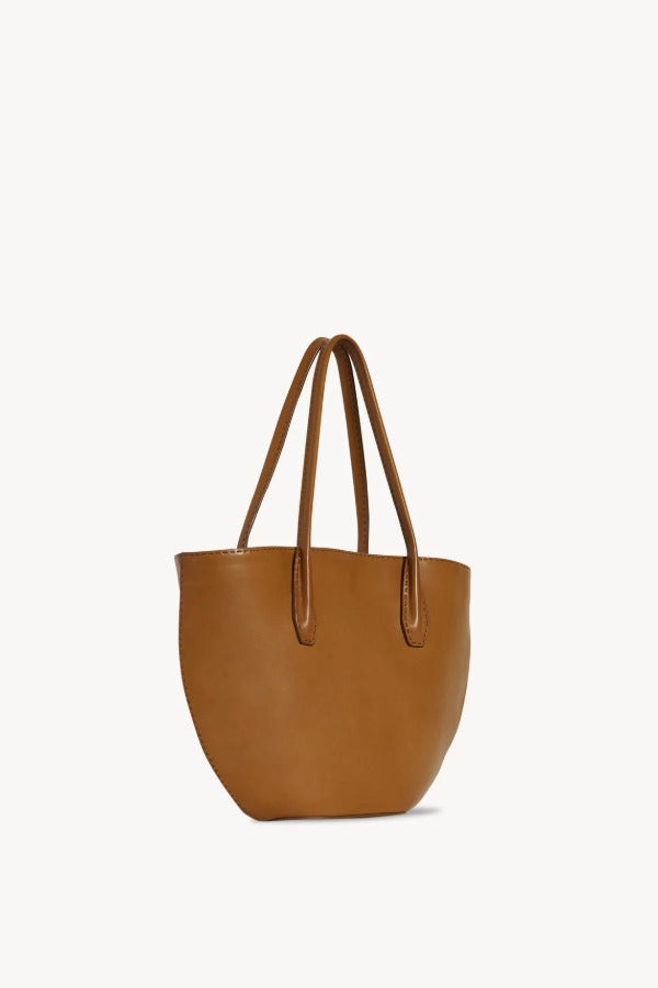 Front slanted view of cuir alger tote on white background, with no model shown.