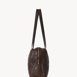 Side view of brown astra bowling bag on white background, with no model shown.
