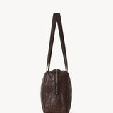 Side view of brown astra bowling bag on white background, with no model shown.