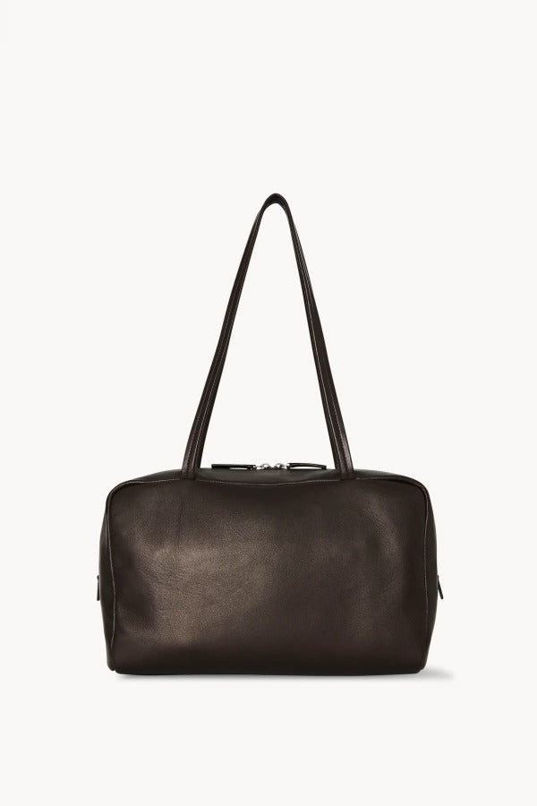 Front view of dark brown astra bowling bag on white background, with no model shown.