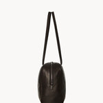 Side view of dark brown astra bowling bag on white background, with no model shown.