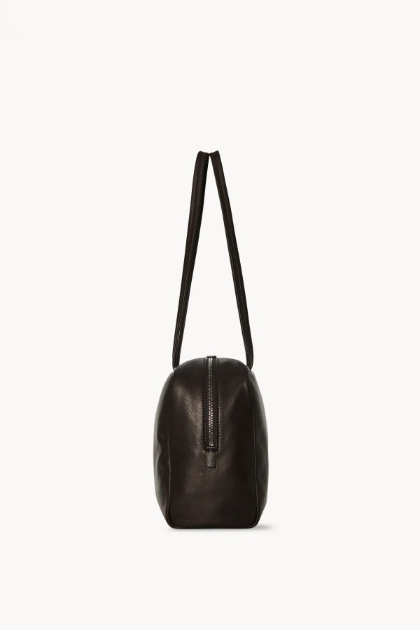 Side view of dark brown astra bowling bag on white background, with no model shown.