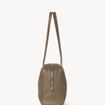 Side view of smoked taupe astra bowling bag on white background, with no model shown.