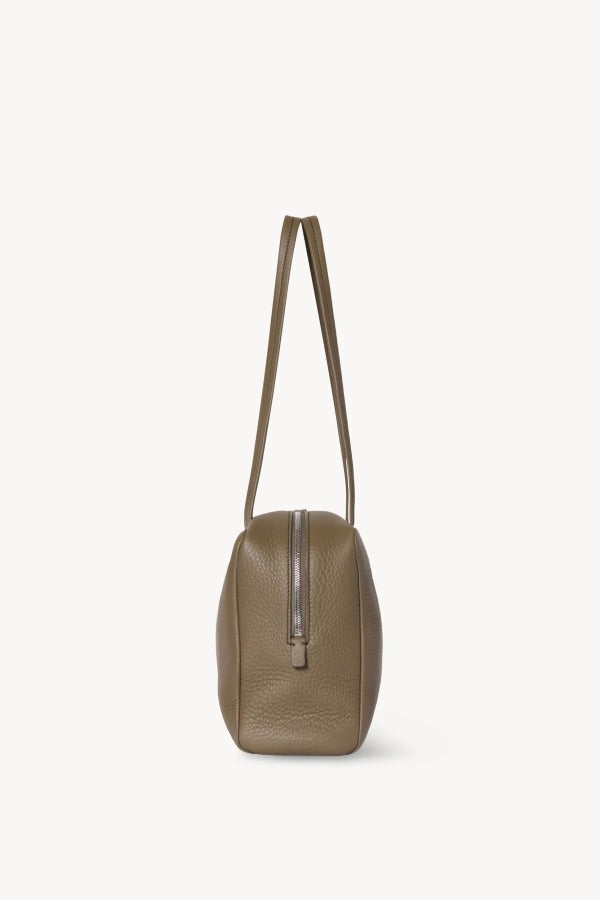 Side view of smoked taupe astra bowling bag on white background, with no model shown.