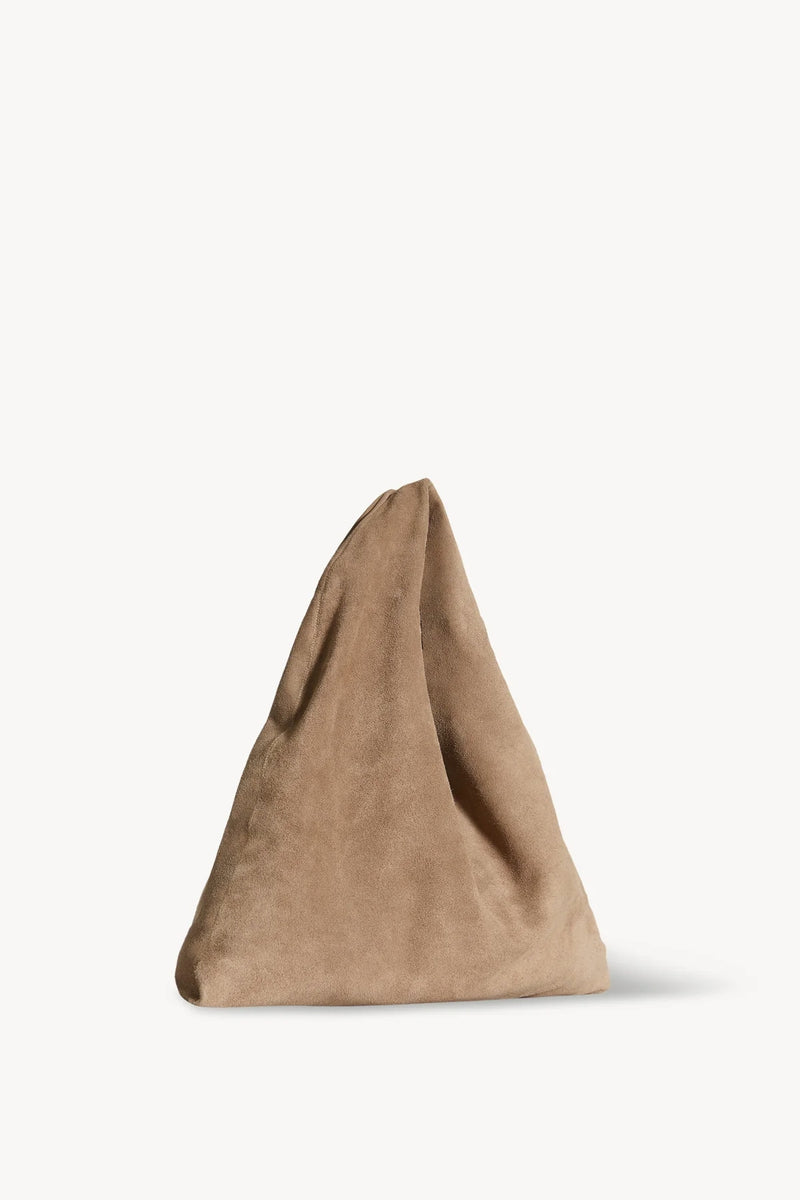 Side slanted view of beige melange suede bag on white background with no model shown.
