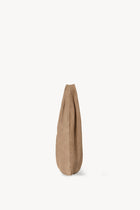 Side view of beige melange suede bag on white background, with no model shown.