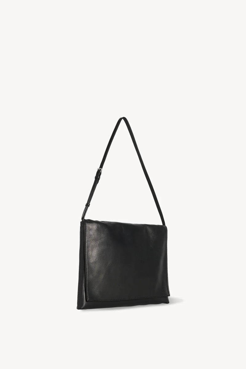 Side slanted view of black leather bag on white background, with no model shown.