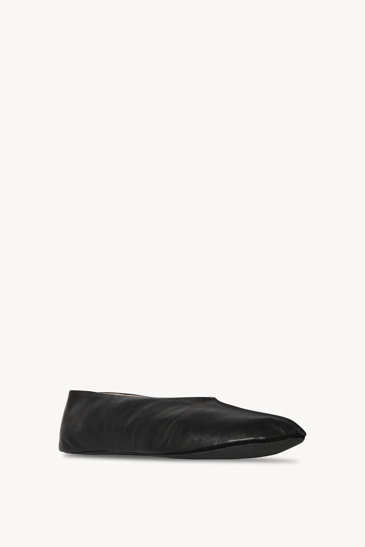 Front slanted view of black stella slipper on white background, with no model shown.