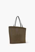 Side slanted view of a mesh and leather blue bag pictured on a white background, with no model shown.