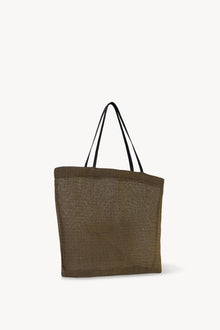 Side slanted view of a mesh and leather blue bag pictured on a white background, with no model shown.