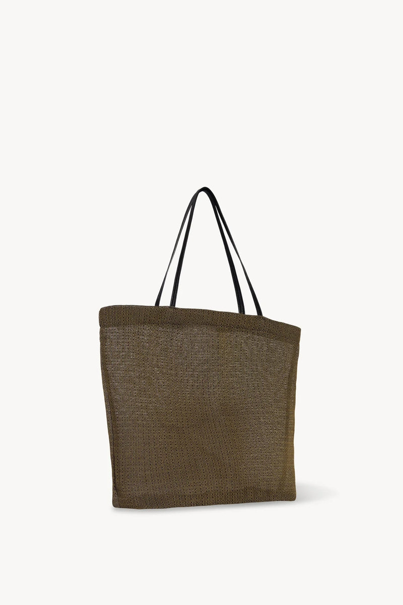 Side slanted view of a mesh and leather blue bag pictured on a white background, with no model shown.