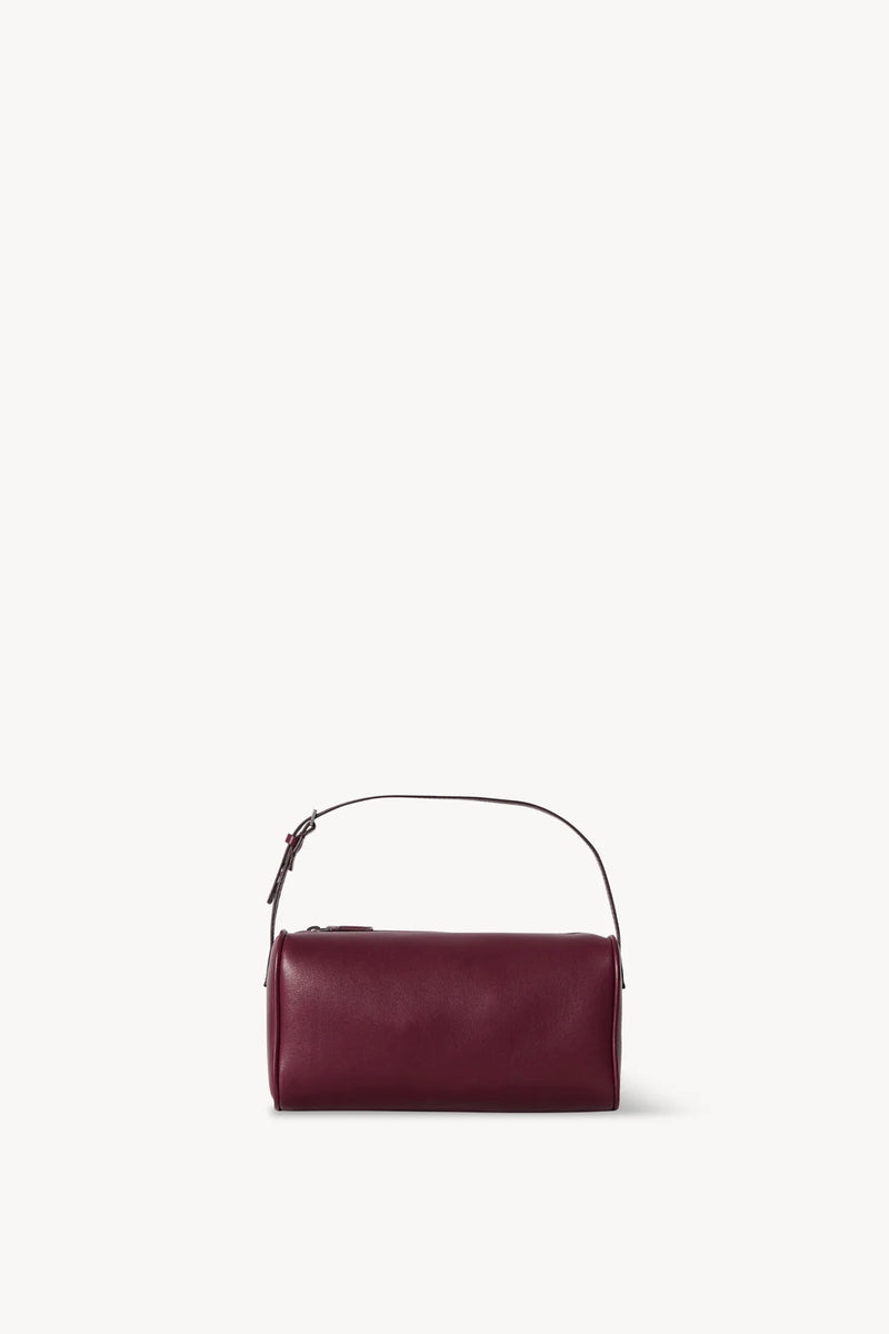 Front view of a purple leather bag on a white background, with no model shown.