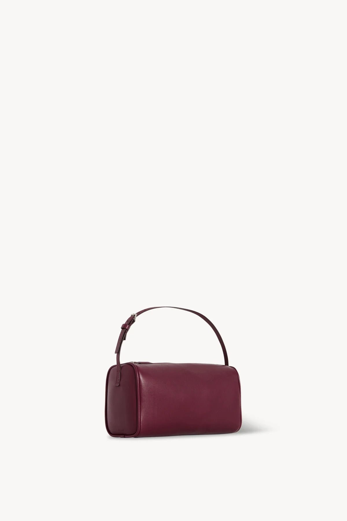 Side slanted view of a purple leather bag on a white background, with no model shown.