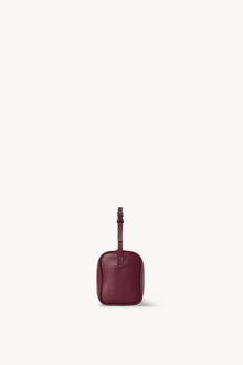 Side view of a purple leather bag on a white background, with no model shown.