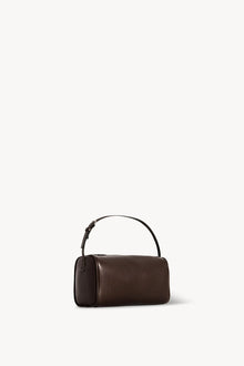 Side slanted view of a brown melange leather bag on white background, with no model shown.