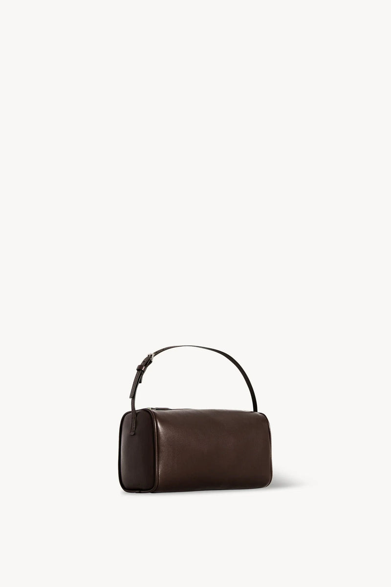 Side slanted view of a brown melange leather bag on white background, with no model shown.