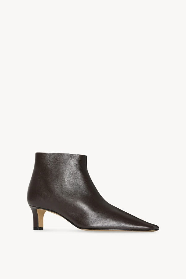 Front slanted view of lacquer brown carla boot on white background, with no model shown.
