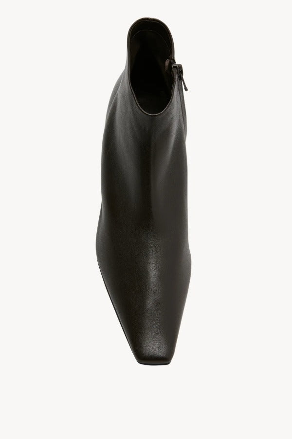Overhead view of lacquer brown boot on white background, with no model shown.