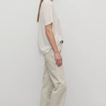Side view of ice carlyl pant on model wearing white t-shirt and sneakers, against a white background.