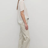 Side view of ice carlyl pant on model wearing white t-shirt and sneakers, against a white background.