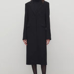 Front view of black cerys coat on model wearing black heels, against a white background.